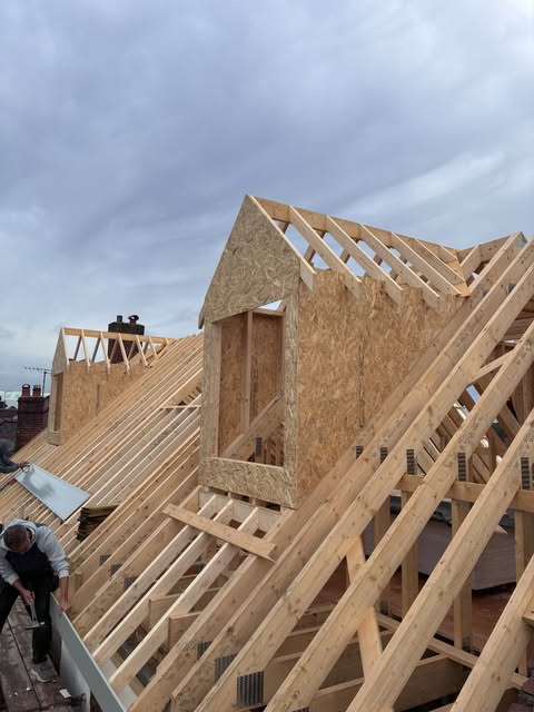 Attic roof trusses and a dormer frame installed on a roof in Shenfield
