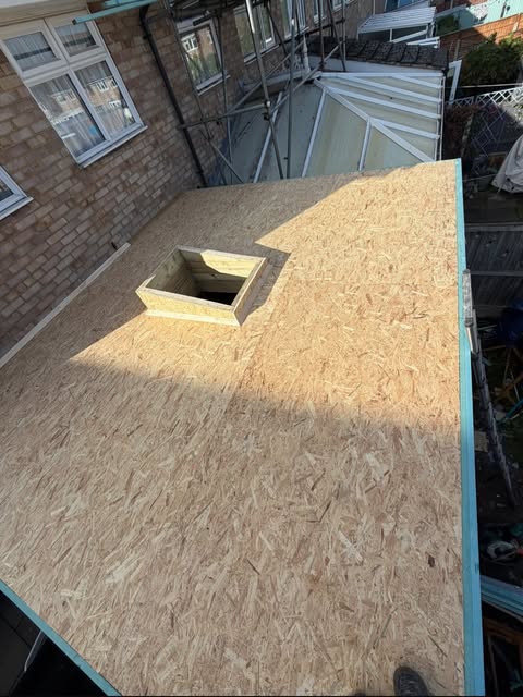 New flat roof deck over a replaced conservatory roof in Chelmsford, with a trimmed rooflight opening