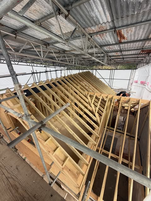 Hand-cut roof structure and vaulted ceiling framing on a timber frame extension